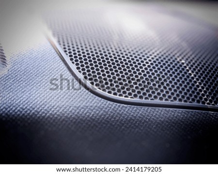 The surface of the speaker is inside the car.