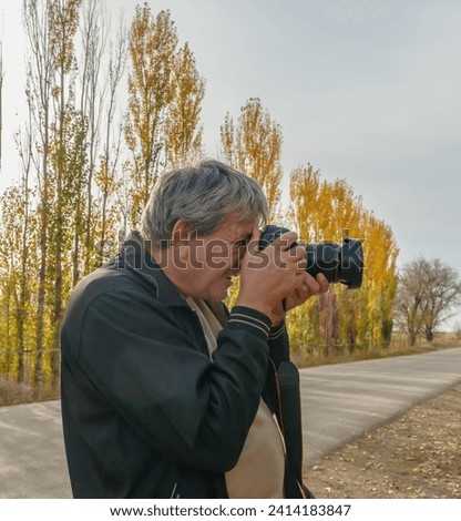 Photographer shooting nature style pictures in country field