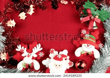 A Christmas scene with Santa Claus, reindeer, a snowman, bells, and snow is set against a red background. There is a space for a message.
