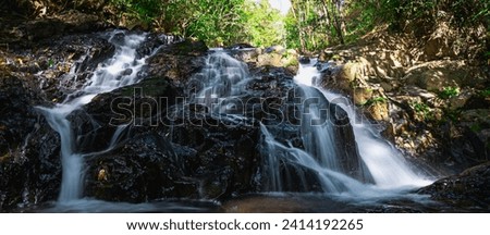 Photo of a small waterfall hidden deep in the forest in Da Lat city, few people know about it so it is still wild. Pictures taken at slow speed create a softness like a white silk strip in the middle 