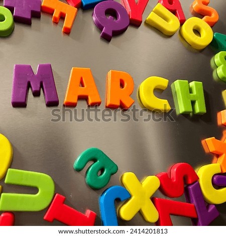 March written in magnetic letters on a refrigerator