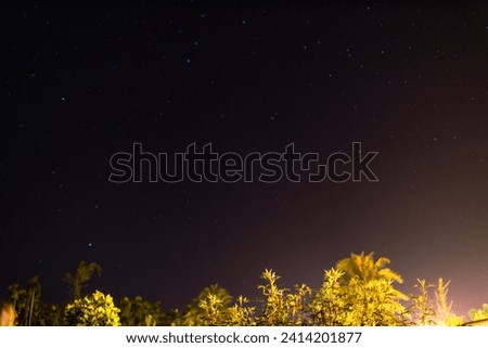 Abstract background of nature at night with stars, moon visible. Shining beautiful light, seeing the Milky Way blurry, there is a large forest covering the cool air.