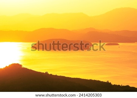 Natural background, high angle view from the observation point, blurred golden rays of the sun visible. The mountains that were setting on the horizon, changed beautifully with the wind.
