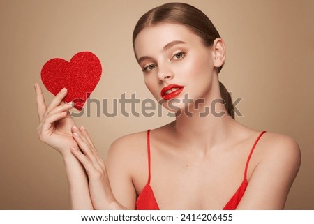 Beautiful young woman holding an artificial red heart. Valentine's Day - Holiday, Women, Valentine Card, One Woman Only, Heart Shape Royalty-Free Stock Photo #2414206455