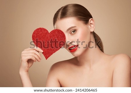 Beautiful young woman holding an artificial red heart. Valentine's Day - Holiday, Women, Valentine Card, One Woman Only, Heart Shape Royalty-Free Stock Photo #2414206465