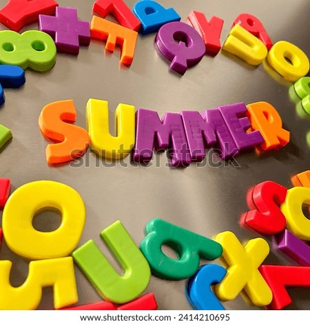Summer written in Magnetic letters on a refrigerator