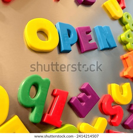 Open written in Magnetic letters on a refrigerator