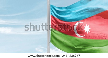 Azerbaijan national flag waving in beautiful clouds.

