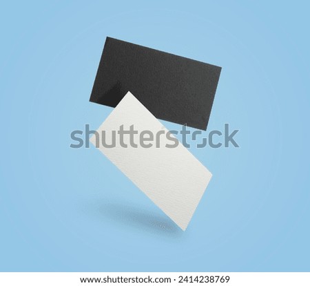 Blank business cards in air on light blue background. Mockup for design