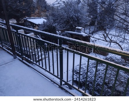 Terrace and balcony under a heavy layer of snow, early morning, natural beauty, cold and frosty environment, fresh air, with leafless vegetation and tree branches, metal and urban structure