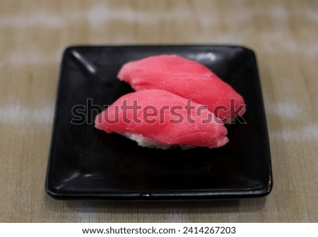 Nigiri Sushi with tuna on wooden table background