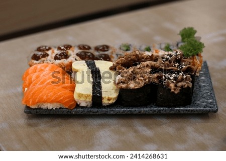 Various kinds of sushi served on glass plates
