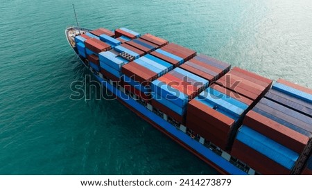 logistic cargo container ship sailing in sea to import export goods and distributing products to dealer and consumers across worldwide, aerial side view from drone, Royalty-Free Stock Photo #2414273879