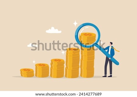 Investment or financial analysis, wealth management or revenue growth, economic or profit improvement, income or portfolio analysis concept, businessman with magnifying glass on growth coin stack. Royalty-Free Stock Photo #2414277689