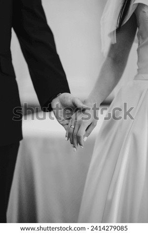 wedding, couple, hands, hold hands, wedding dress suit, tuxedo, shoulders, manicure, wedding rings, black and white, engagement Royalty-Free Stock Photo #2414279085