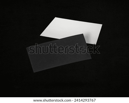 Blank business cards in air on black background. Mockup for design