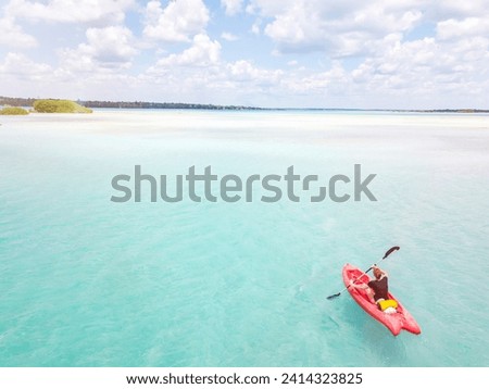 Mexiko- yucatan- quintana roo- bacalar- woman in kayak on the sea in turquoise water- drone image Royalty-Free Stock Photo #2414323825