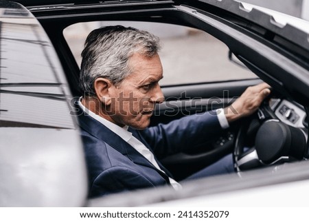 Businessman driving car stock photo