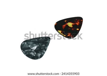 The guitar pick, a small, triangular tool, enhances musical resonance. Its versatile design allows precise strumming and dynamic note articulation, shaping the guitarist's sonic expression.