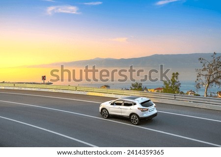 car drive on the road of Mediterranean beach. Highway view on coast on way to summer holiday. driving on coast of France. Europe travel trip in blue sea coast road landscape. holiday journey on sunset Royalty-Free Stock Photo #2414359365