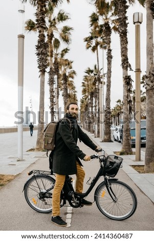 Portrait of man with e-bike on a promenade