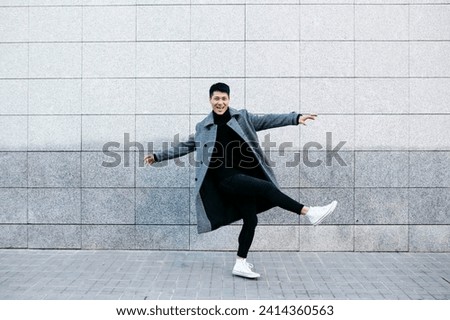 Stylish young man dancing on the street
