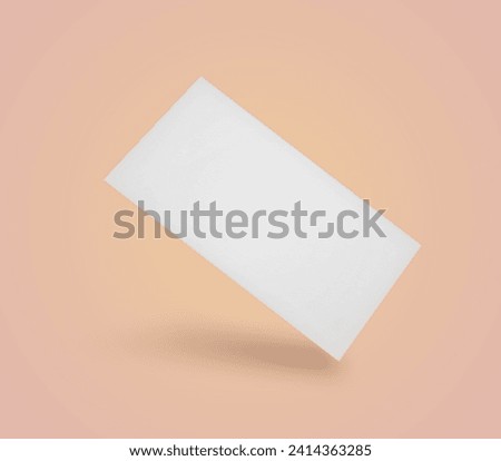 Blank business card in air on peach color background. Mockup for design