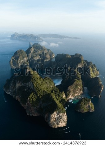 Stunning aerial view of Ko Phi Phi Lee, a ring of steep limestone hills surrounding Maya Bay with Phi Phi Don in the distance. Andaman Sea, Krabi, Thailand. Royalty-Free Stock Photo #2414376923