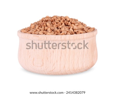 Dry buckwheat in wooden bowl isolated on white