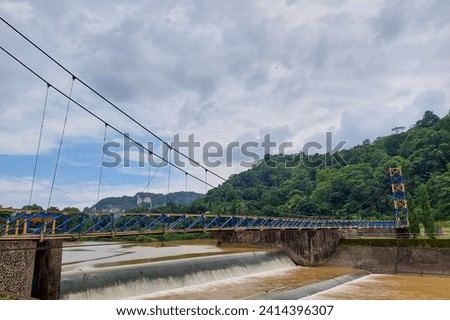 View of the bridge and dam in Tabo-Tabo Village, Pangkep on a cloudy afternoon