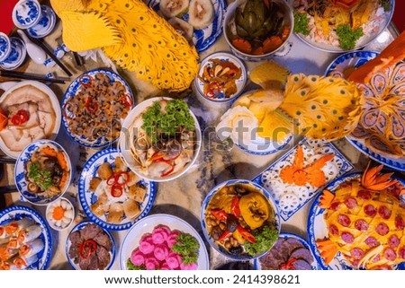 Tet tray. Full of traditional dishes. Chinese new year festival table with asian food. Vietnamese food for Tet holiday in lunar new year. Text on food meaning happy and peaceful. Selective focus.