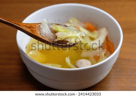 Consommé soup with vegetables and Vienna sausage Royalty-Free Stock Photo #2414423033