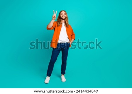 Full body size photo of young handsome blond hair man wearing casual stylish outfit showing v sign isolated on cyan color background
