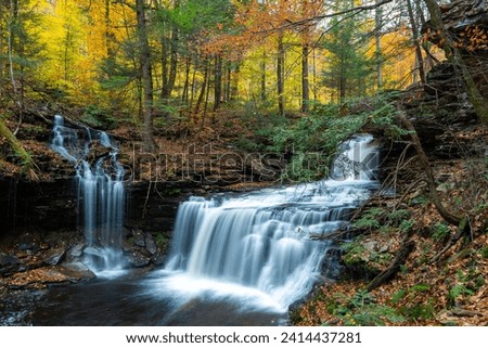 Cascade of waterfalls in a mountain gorge, fast flowing water, long exposure, Waterfalls Ricketts Glen State Park, Pennsylvania Royalty-Free Stock Photo #2414437281
