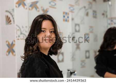 Confident young woman with down syndrome standing in bathroom at home Royalty-Free Stock Photo #2414439363