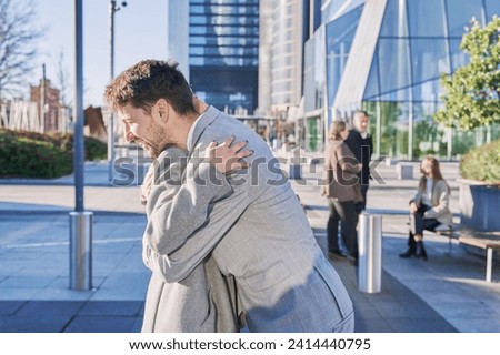 entrepreneurial couple hugging each other goodbye