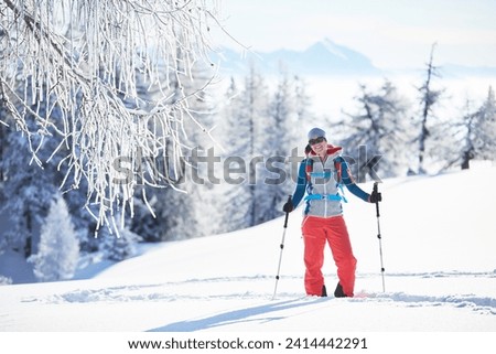 Austria- tyrol- smiling snowshoe hiker standing in snow Royalty-Free Stock Photo #2414442291