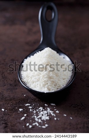 Spoon of coconut flakes stock photo