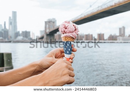 Usa- new york city- brooklyn- close-up of woman at the waterfront holding an ice cream cone