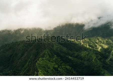 Clouds swirling around mountains of kauai as seen from helicopter. High quality photo