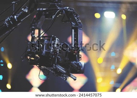 TV camera on a crane at a football match or concert. Close-up live video broadcast camera.