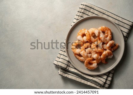 Cooked shrimps in a plate, seafood, bright background, copy space