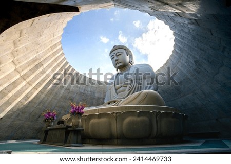 Hill of the Buddha, a Buddhist shrine features a 13.5 m (44 ft) tall statue of the Buddha encircled by an artificial hill, at Makomanai Takino Cemetery in Takino Suzuran Hillside Park, Sapporo Royalty-Free Stock Photo #2414469733
