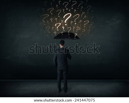 Businessman with umbrella and a lot of drawn question marks concept on background