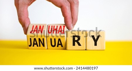 Januhairy or January symbol. Concept words Januhairy or January on beautiful wooden blocks. Beautiful yellow table white background. Man hand. Social issues Januhairy or January concept. Copy space.