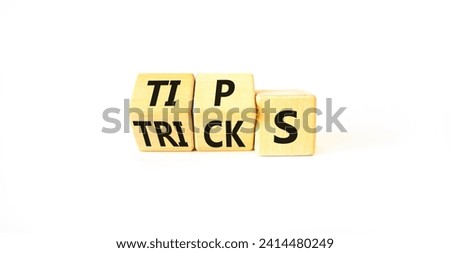 Tips and tricks symbol. Turned wooden cubes and changed the word tricks to tips. Beautiful white table, white background. Business, tips and tricks concept. Copy space.