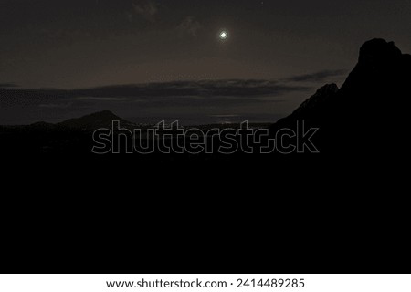 View of Trois Mamelles mountain, the full moon and the west coast of Mauritius island at night