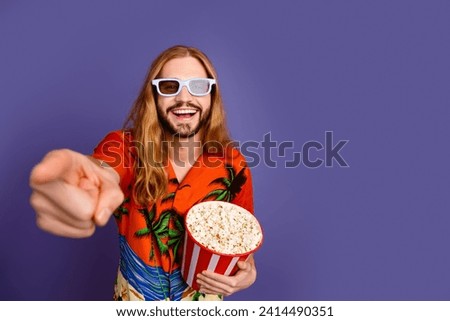 Photo of positive man in 3d glasses hold popcorn laugh at funny scene in comedy directing at you isolated on violet color background