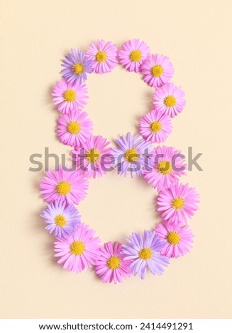 International Women's day, March 8th concept. Number eight 8 made of pink and purple asters flowers on beige background. Flower fonts, shape. Creative spring idea, stylish trendy greeting card