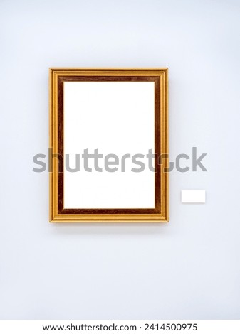 Mockup white blank space in gold wooden square picture frame, vertical style, isolated. Empty single vintage brown rectangular simple photo frame hanging on white wall background with empty caption.